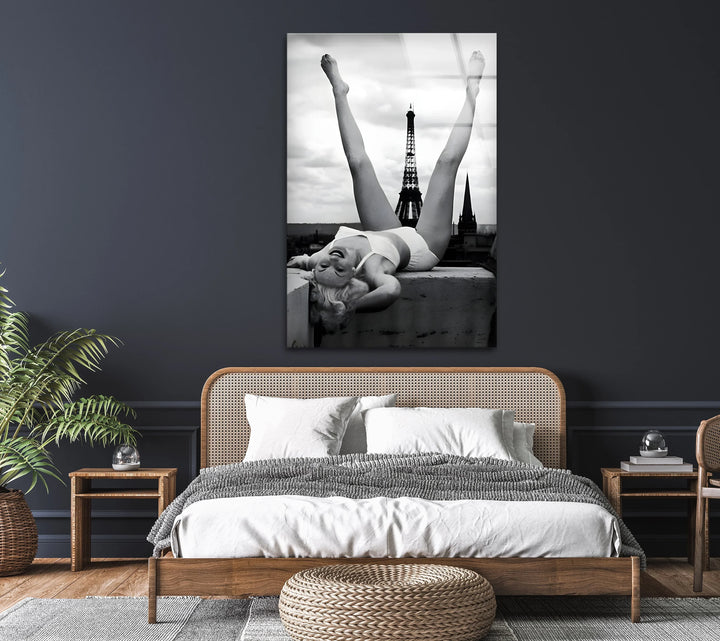 Paris rooftop scene in monochrome featuring a woman in a playful reclining position.