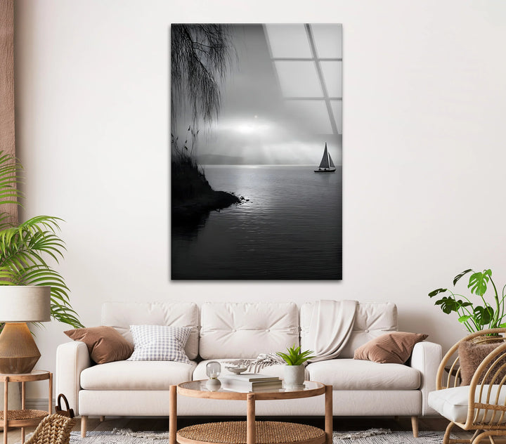 Serene sailboat silhouette on reflective water in modern black and white glass art.