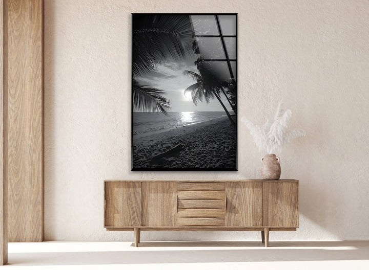 Tropical beach artwork in black and white on glass with soft evening light.