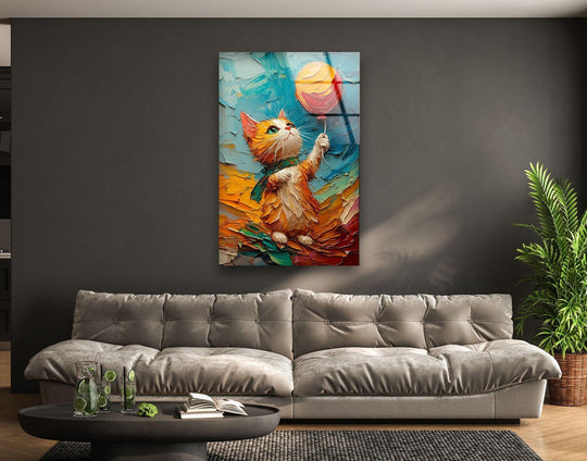 A vertical glass wall art of a playful orange cat holding a balloon, presented as unique modern wall decor.