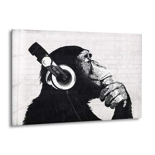 Black and white glass wall art of a Banksy DJ monkey with headphones a modern pop art design and iconic piece of street art wall decor