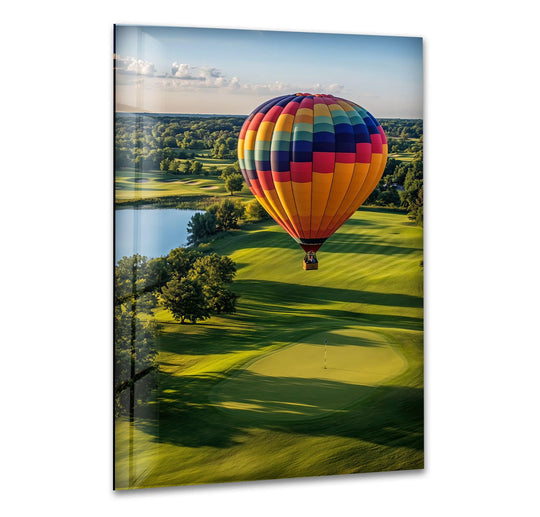Vibrant color contrast highlights the best glass art, showcasing a hot air balloon's vivid hues against a lush green golf course landscape below.