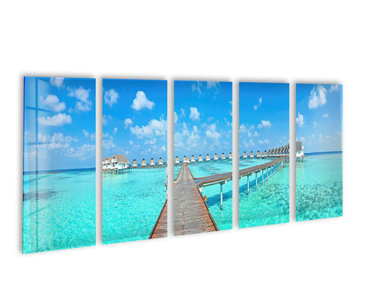 Fluffy white clouds offer the softest element in this five-piece Bungalows Maldives Island Landscape glass wall art, perfect for a tranquil home decoration.