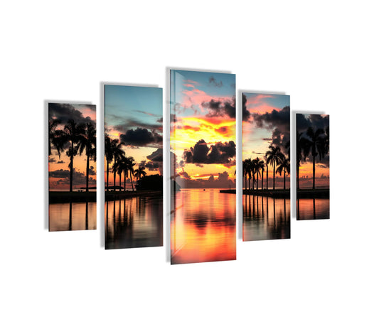 This glass wall art shows a paradise beach sunset and tropical palms and it is a five piece wall art set for a tropical home decor accent and wall art decor.