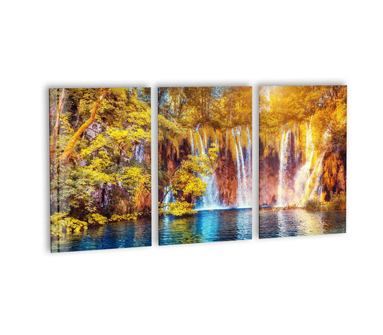 Waterfall and lake landscape glass wall art showcases nature scenery and autumn colors a triptych wall decor reflecting blue lake water and golden yellow foliage