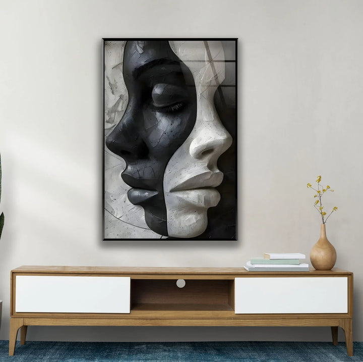 Grayscale glass wall art of dual female faces fused together in a textured abstract style.