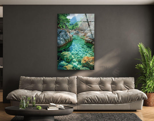 Reflecting light, the canyon stream glass wall art prints showcase a polished surface, highlighting the textured rocks and crystal-clear water.