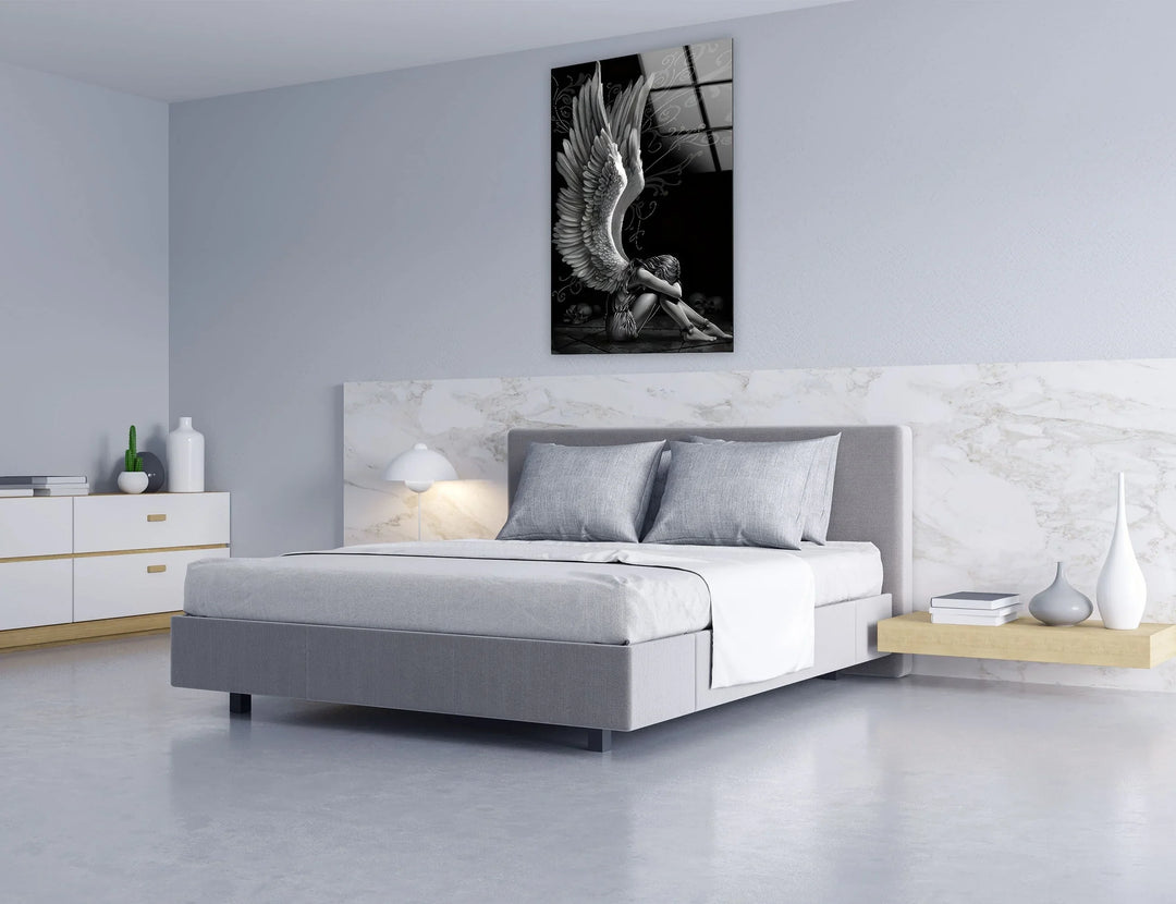 Abstract black and white angel depiction on glass with intricate wings and a somber atmosphere.