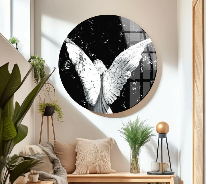 Monochrome angel figure on tempered glass with fully extended wings and a bold dark setting.