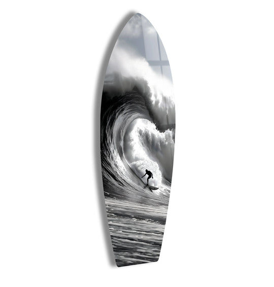 Foreground detail showcases a surfer skillfully riding a powerful, curling wave depicted on this black and white surfboard tempered glass wall art.
