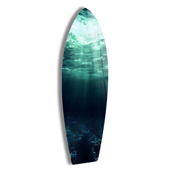 The surfboard features an underwater ocean scene with deep blue waters and sunlight making it stunning ocean and sunlight decor as glass wall art