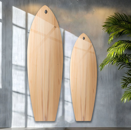 Two surfboard wall art pieces crafted with wood details provide a unique modern wall decor accent with light playing across the grain.