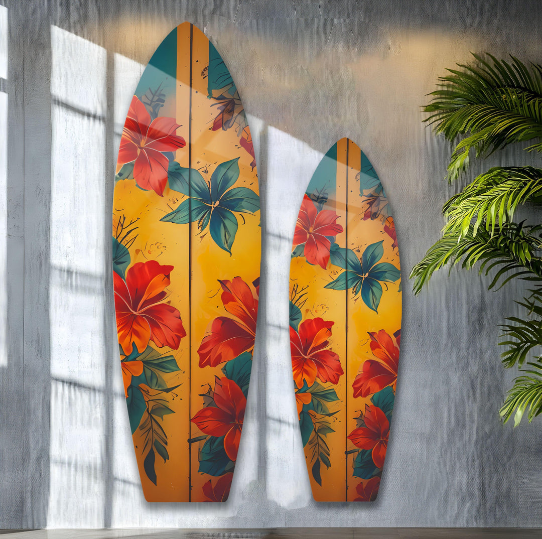 Sunlit textured gray walls and a leafy palm create a coastal-chic backdrop for this decorative wall art featuring vintage surfboard flower designs.