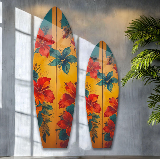 Sunlit textured gray walls and a leafy palm create a coastal-chic backdrop for this decorative wall art featuring vintage surfboard flower designs.