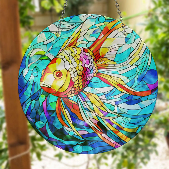 Brightly illuminated, the goldfish suncatcher's face in this glass art painting draws the eye with its vibrant scales and water bubble accents.