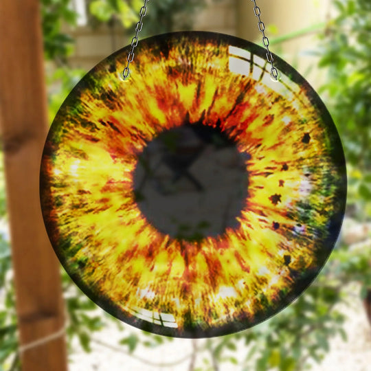 Alternating shades of yellow and red emanate from the center of the Yellow Eye Suncatcher Decor, creating a compelling visual rhythm like concentric wall prints.