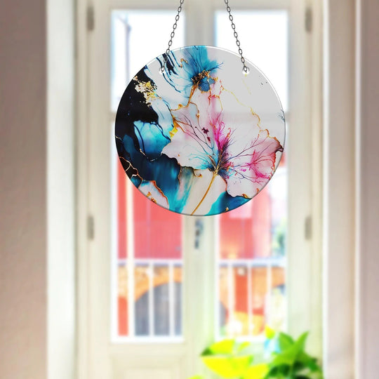 Organic forms swirl in a contemporary glass suncatcher featuring a marble flower design, showcasing unique modern wall decor.