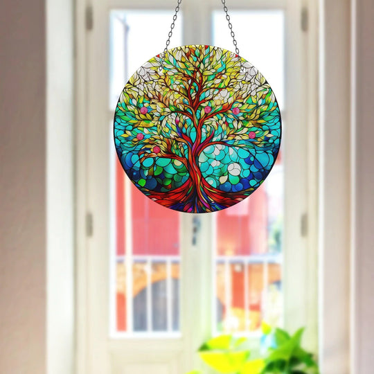 Visual rhythm is created by a circular tree of life design, a striking glass wall artwork suncatcher with an organic arrangement of colors, shapes, and textures.