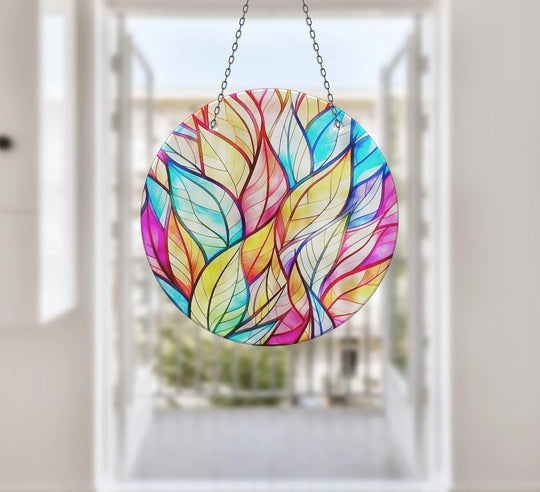 A cheerful mood radiates from this stained leaf suncatcher, a colorful glass wall artwork, bringing a vibrant and artistic touch to any window or space.