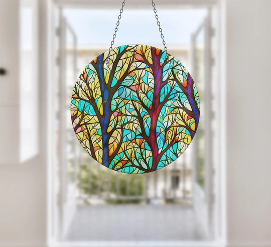 Suncatcher featuring tree leaves in blue yellow and red with vibrant glass wall art decor and colorful glass art for the wall