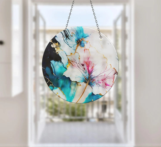 Stillness in the marble flower suncatcher design captures a moment of serene glass art, suspended in light, with delicate details of blue and gold.