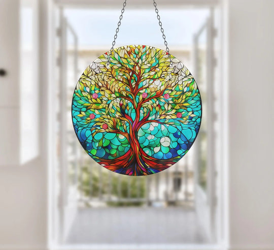 Softly blurred French doors create a bright background behind the vivid tree of life green suncatcher, a stunning piece of hanging wall art.