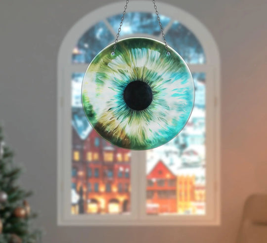 Organic forms create a mesmerizing swirl in this green eye suncatcher, a unique piece of the best glass art reflecting the beauty of the natural world.