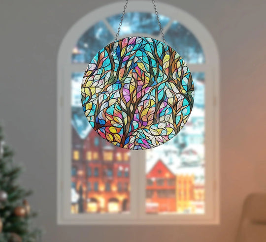 Vibrant color contrast defines this leaves suncatcher, a piece of unique modern wall decor, showcasing a colorful, stained glass design in front of a blurred window.
