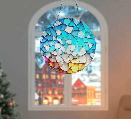 Rippling with color, the stained blue and yellow suncatcher appears in motion, a vibrant display of best glass art suspended before a blurred, festive window.