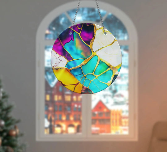 Featuring the abstract quality of the Marble Purple & Blue Suncatcher, this decorative wall art is an array of fractured colors joined by golden lines, creating a stained glass effect.