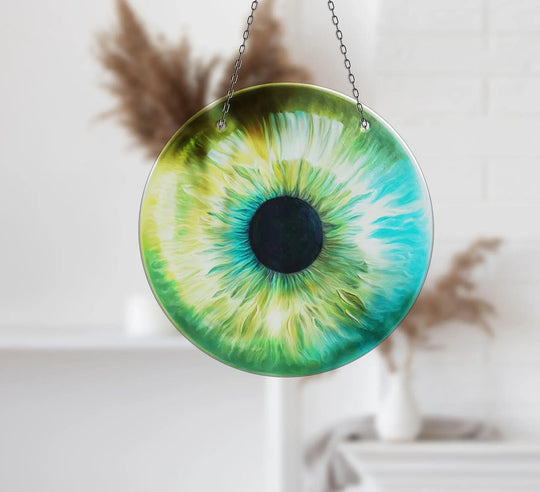 Delicate layering effect in this green eye suncatcher shows the detailed artistry of the art from glass, creating a mesmerizing, circular window decoration.