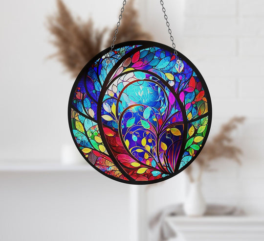 Negative space highlights the branching tree design within this colorful blue suncatcher decor, adding depth to its charming home decoration aesthetic.