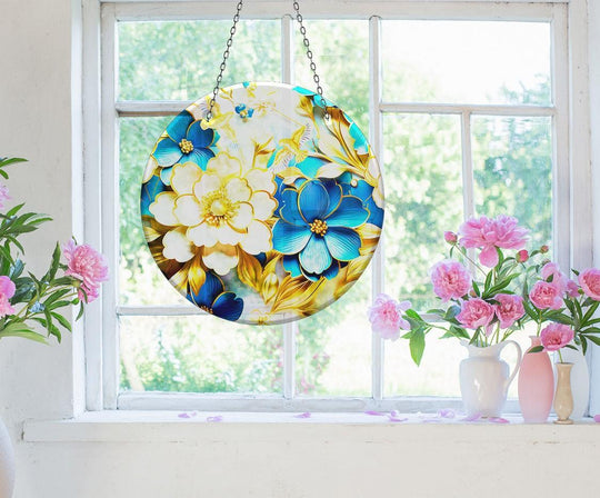 Foreground peonies and a suncatcher featuring white and blue flowers add decorative wall art to a bright window, creating a colorful display.