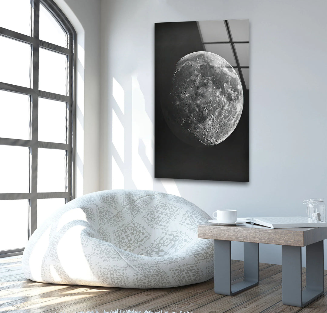 Detailed grayscale moon imagery on glass capturing the rugged texture of its craters and ridges.