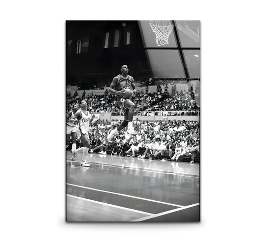 The black and white Micheal Jorden glass wall art shows a basketball player and it is a stunning glass wall art piece and black and white wall decor for sports fans