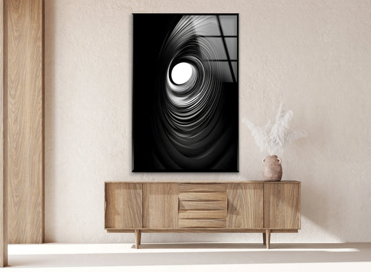 Black-and-white spiral glass wall art with a sleek black border showcases a striking abstract design as decorative wall art.