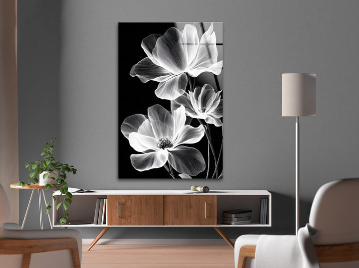 High-definition black and white glass wall art capturing the beauty of glowing flowers against a dark background.