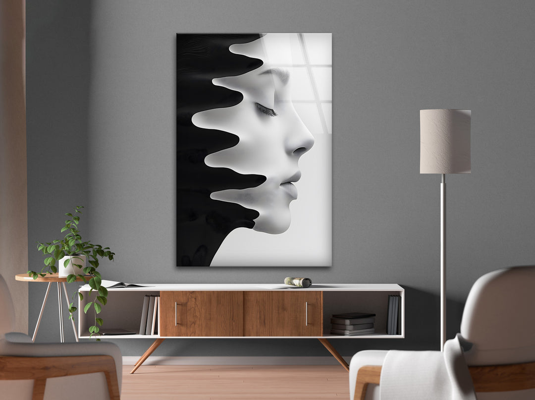Minimalist glass artwork showcasing a flowing black-and-white face design.
