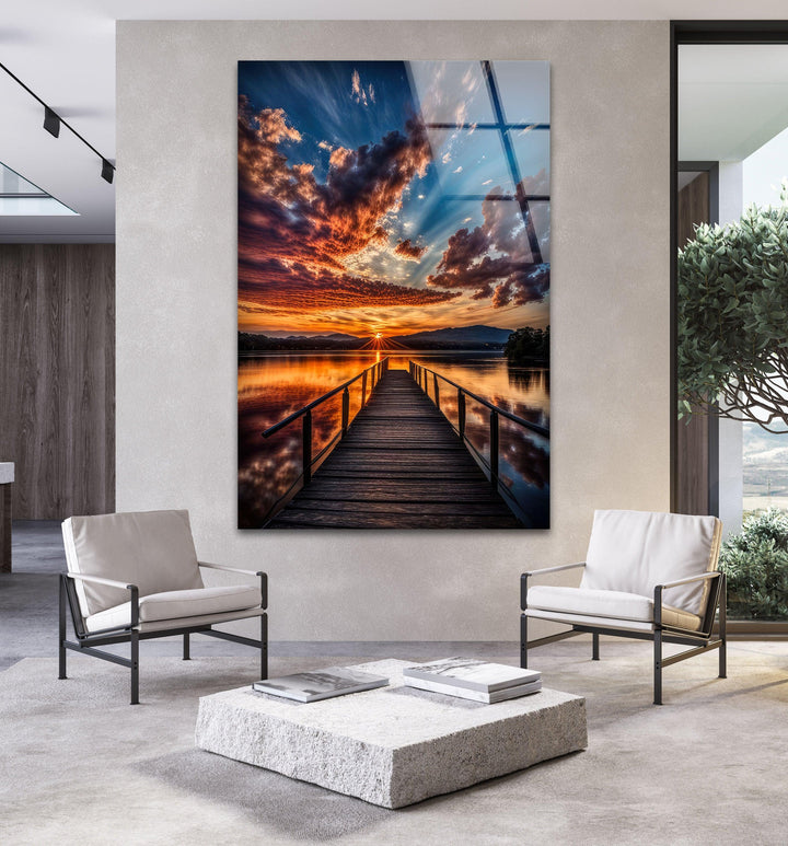 Glass wall art displaying a stunning sunset with vivid colors and reflections.

