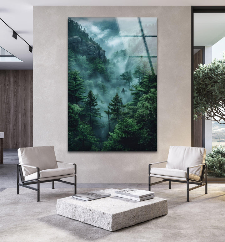Glass wall art displaying a mystical green forest with rolling mist.
