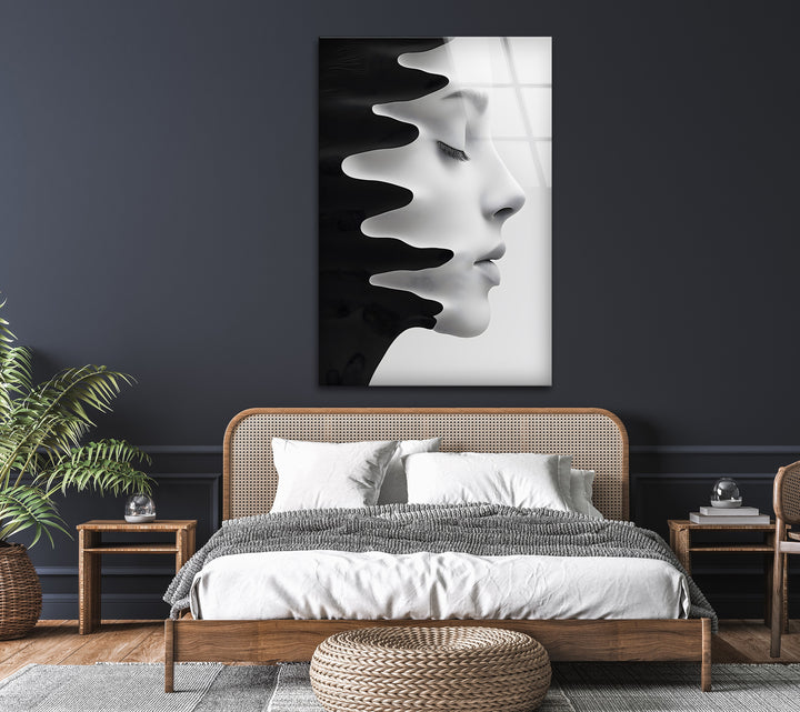 Modern glass wall art featuring a silhouette of a face in fluid motion.
