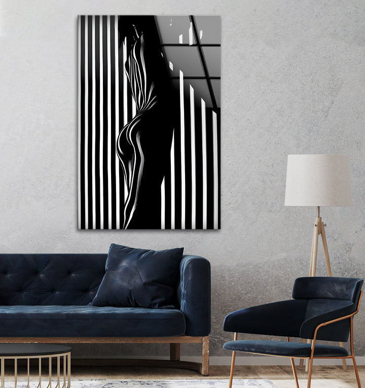 Captivating black and white glass wall art with dramatic light and shadow play on an abstract figure.