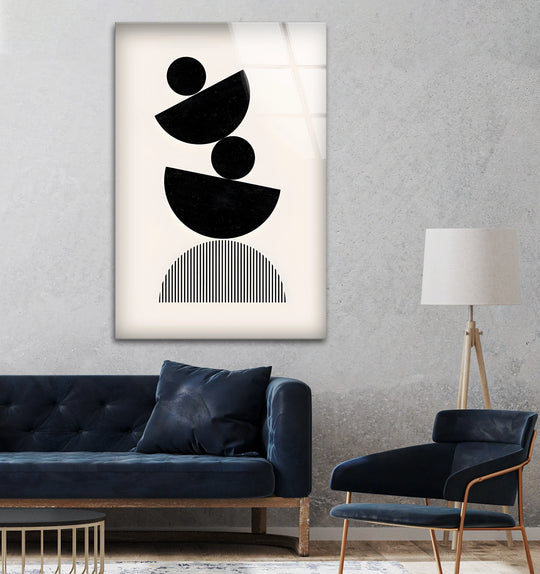 A tall, vertical decorative wall art featuring stacked black geometric shapes including circles and semicircles on a cream background.