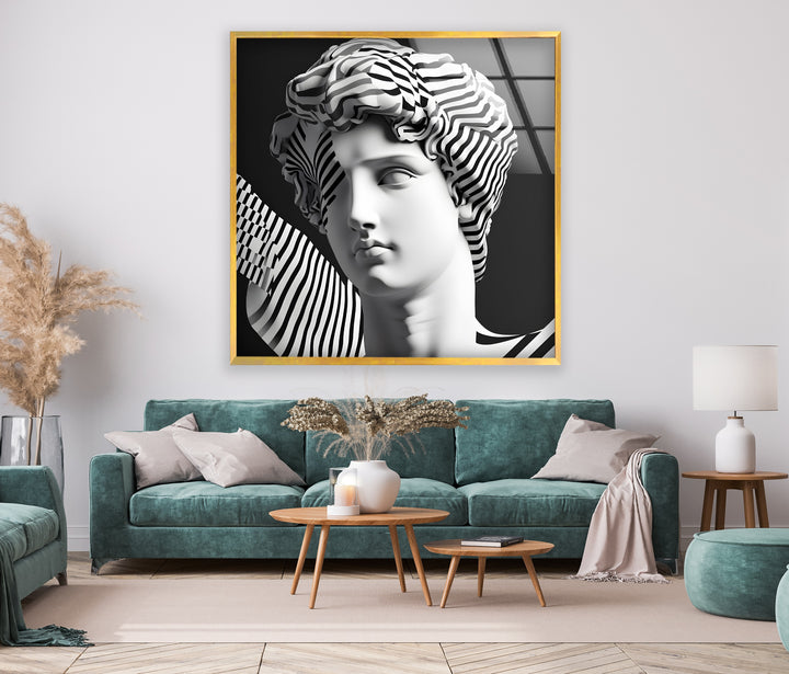 Abstract Art with a Sculptural Twist: Glass wall art with dramatic black and white stripes surrounding a classical sculpture.
