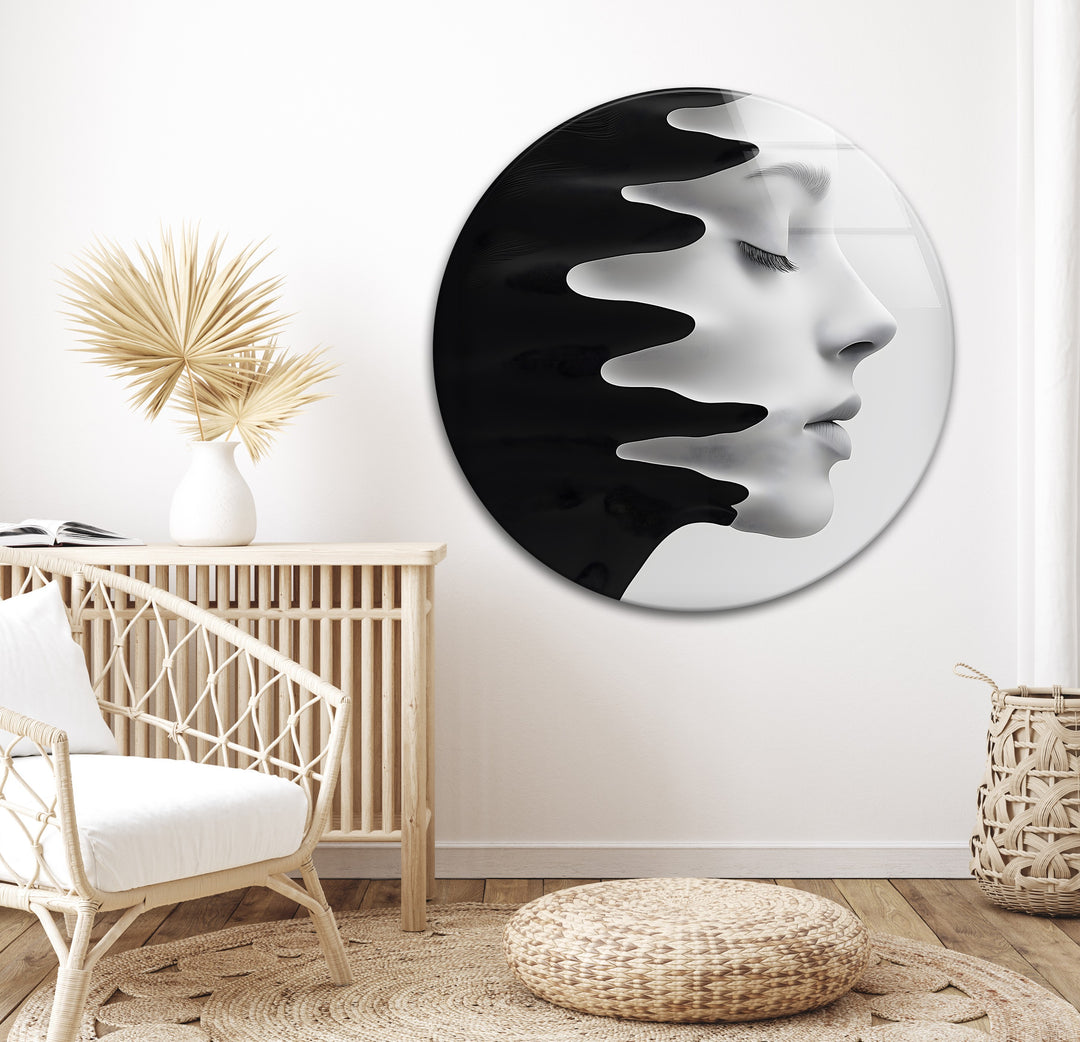 Modern glass piece depicting a flowing face, merging with black liquid forms.

