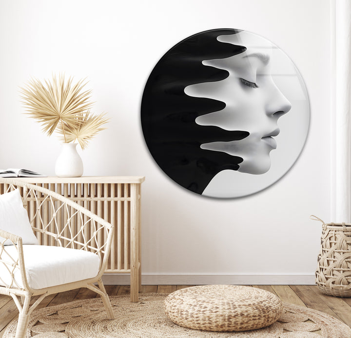 Modern glass piece depicting a flowing face, merging with black liquid forms.
