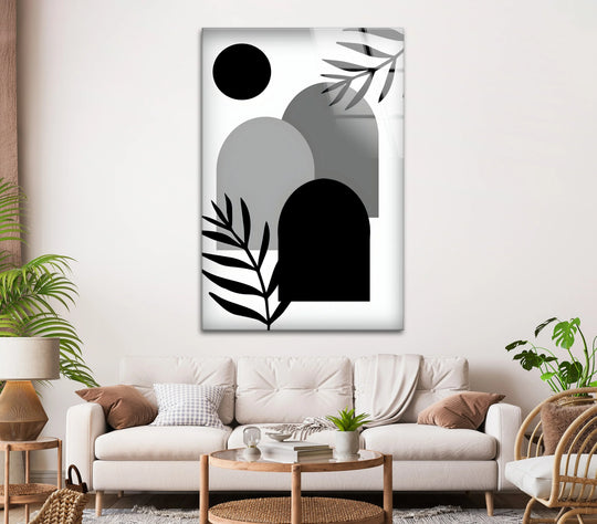 This modern abstract glass wall art features overlapping shapes and botanical elements, creating a sense of depth and layered visual interest.