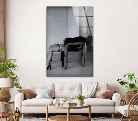 Monochromatic black and white art from glass contrasts a sleek woman against a brightly lit background.