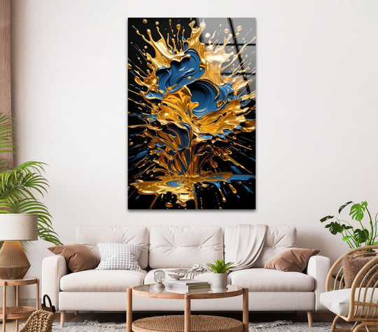 A dark background enhances the dynamic golden and sapphire blue paint splashes, creating a dramatic piece of hanging wall art.