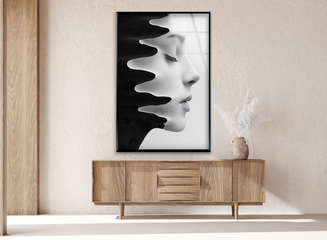 Abstract portrait with flowing black paint on a glass canvas.
